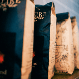 Bags of Iron & Fire's popular Colombian Jazz coffee on a shelf in a cafe